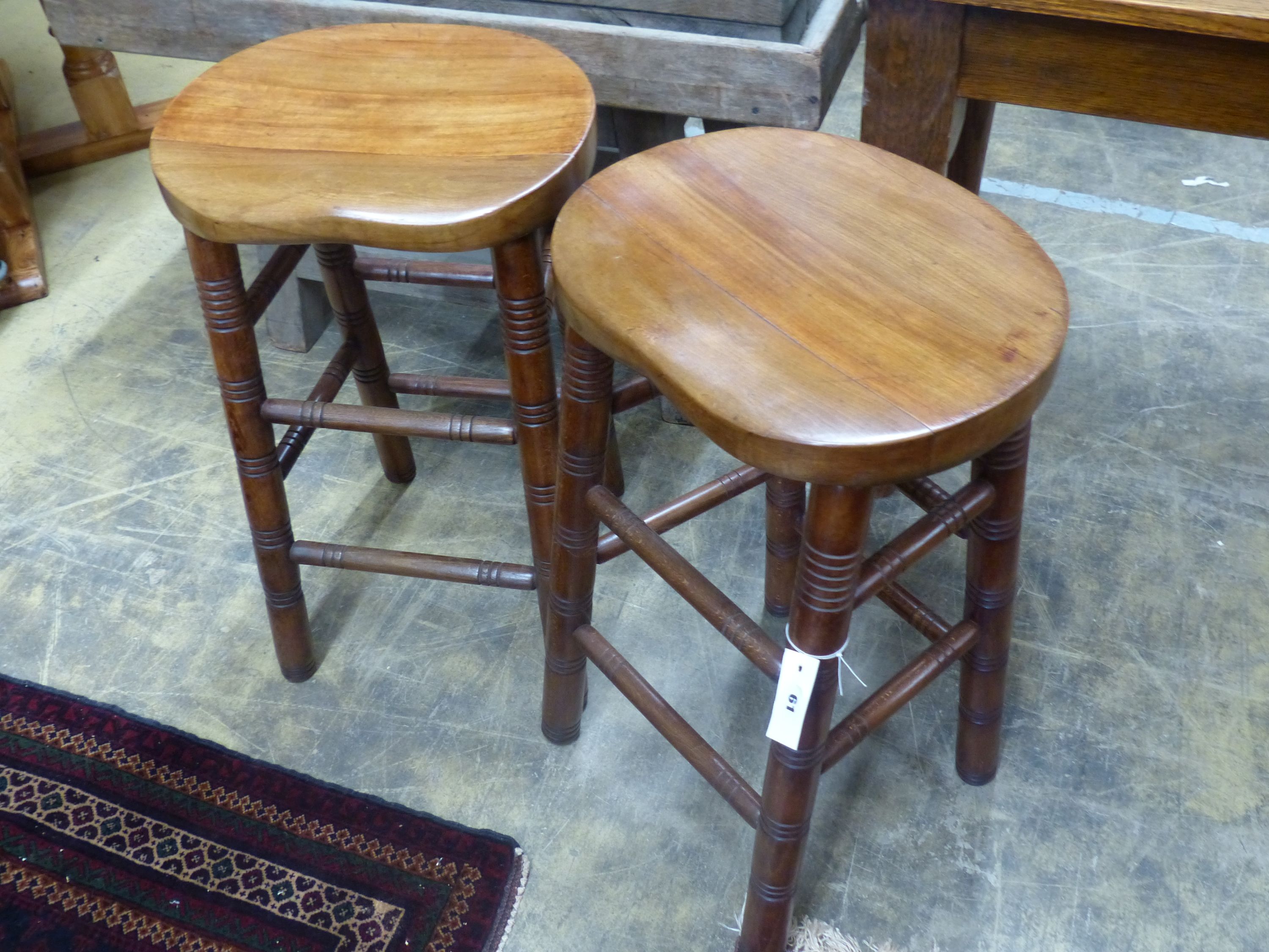 A pair of beech stained bar stools, width 40cm, depth 32cm, height 68cm